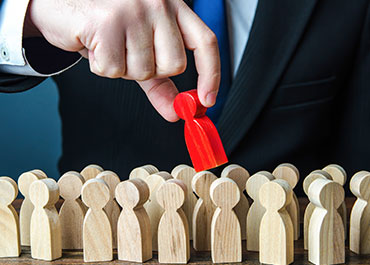Employment discrimination and systemic racism symbolized by selective removal of a red figure.
