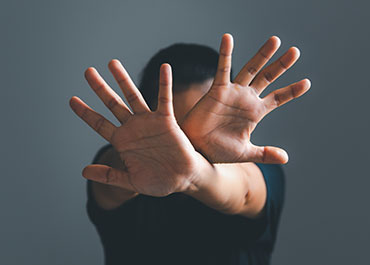 Employee raising hands to stop harassment—legal responsibilities of employers to prevent misconduct.